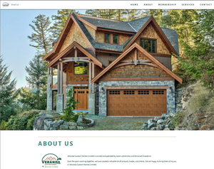 Large wooden framed house with stone around the garage nestled on the side of a tree filled hillside